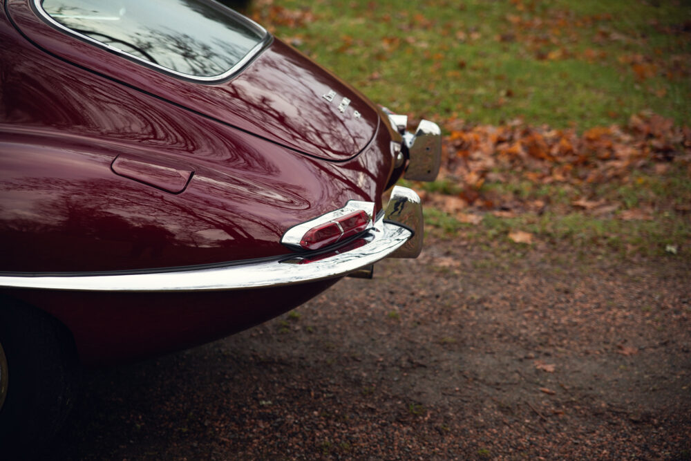 Vintage red sports car rear view on autumn day