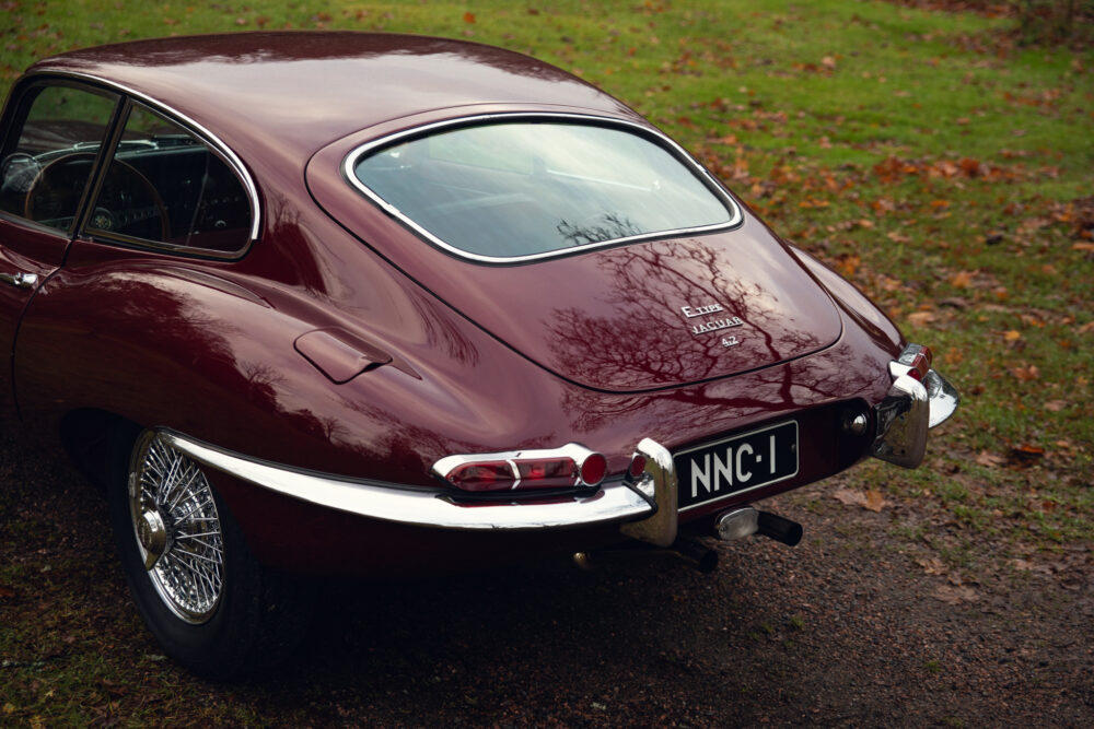 Vintage maroon Jaguar E-Type parked outdoors
