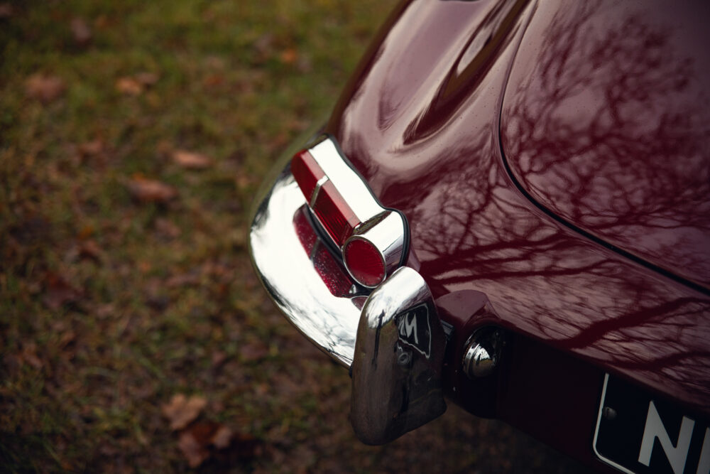 Classic car's taillight and shiny bumper details