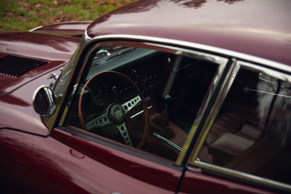 Vintage maroon car with open door showing interior