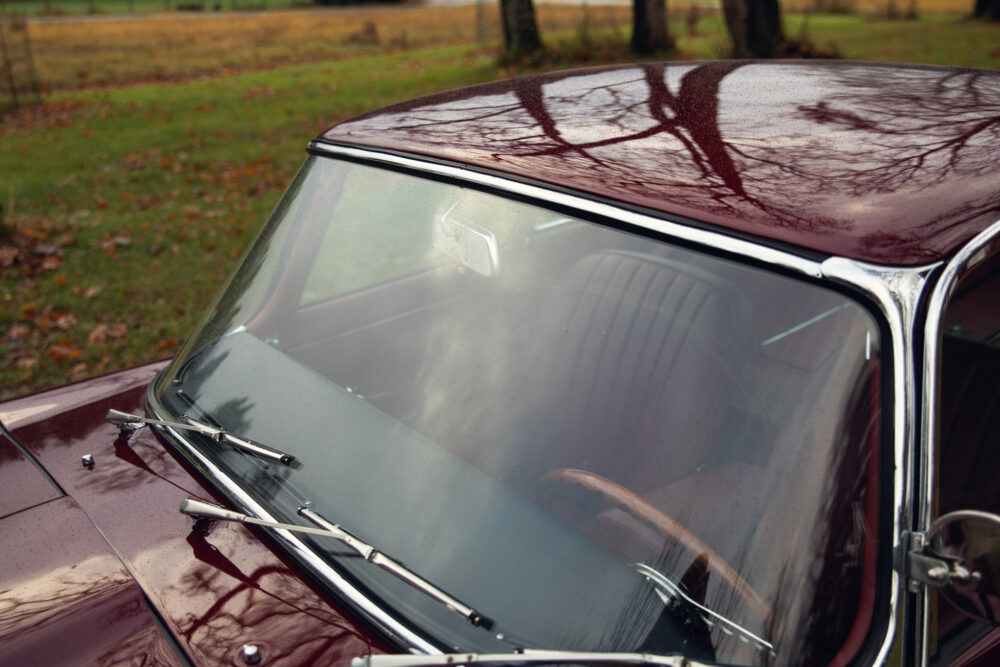 Vintage car's windshield and steering seen from outside