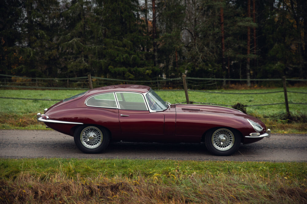 Vintage red Jaguar E-Type on a rural road