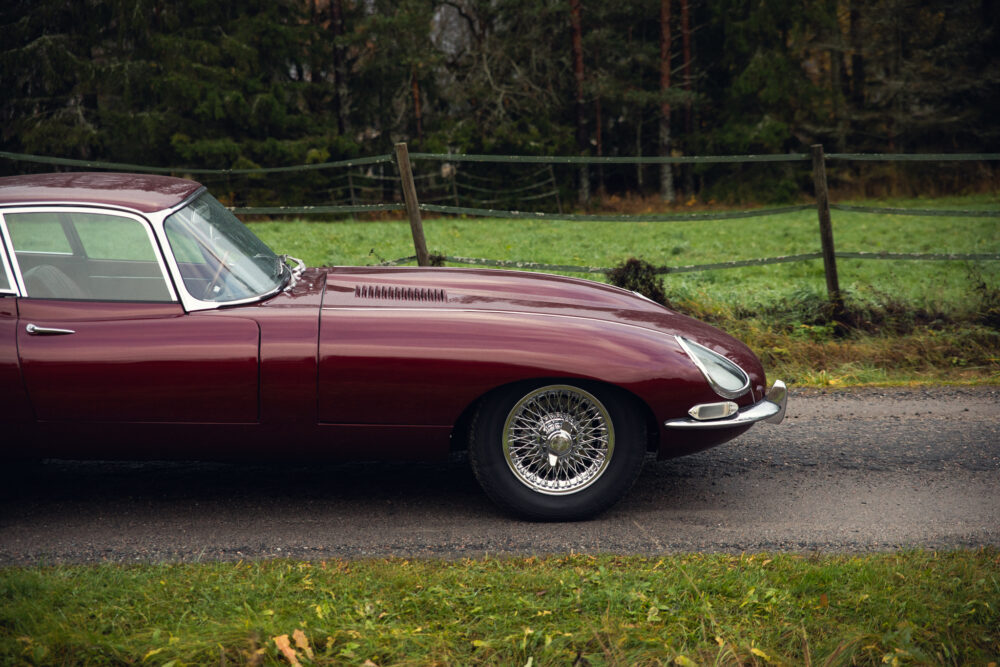 Vintage red car parked on rural road