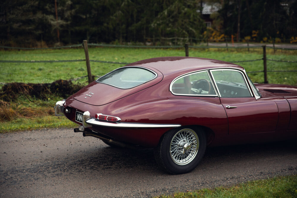 Vintage maroon Jaguar E-Type parked outdoors