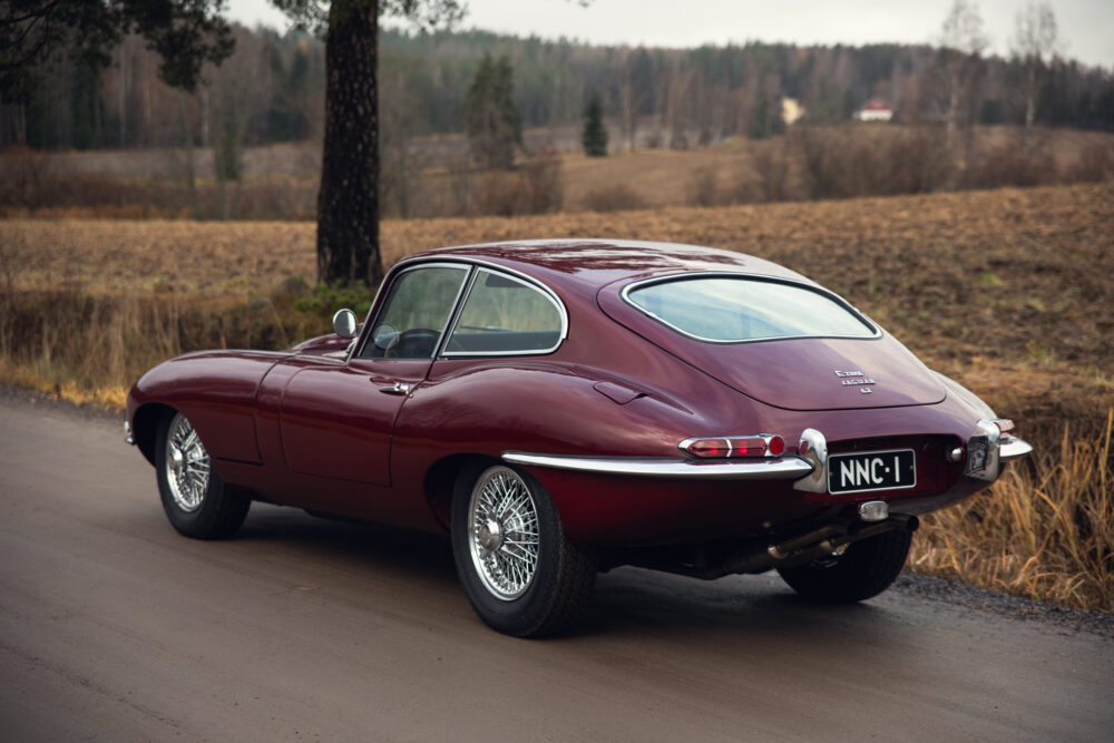 Vintage red Jaguar E-Type on rural road