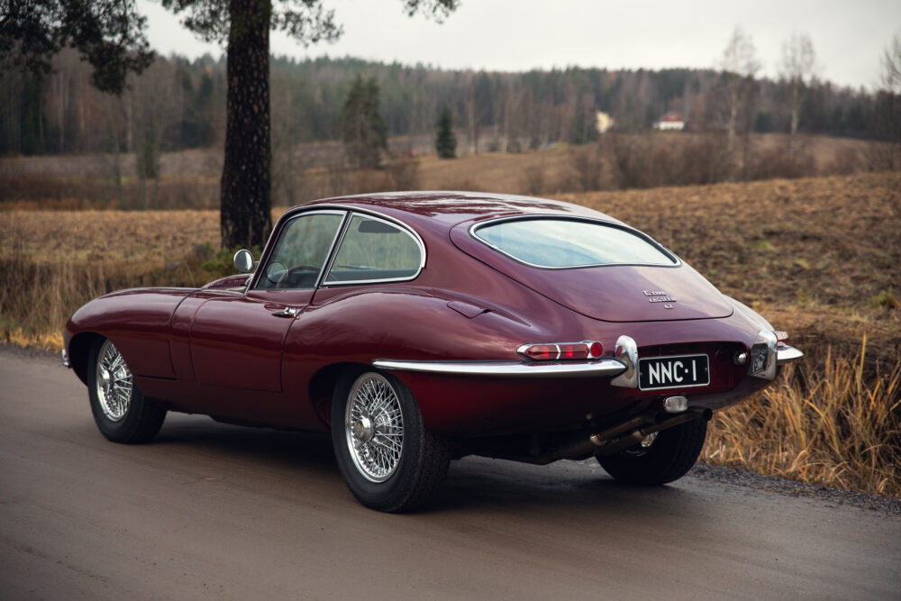 Vintage red Jaguar E-Type on rural road