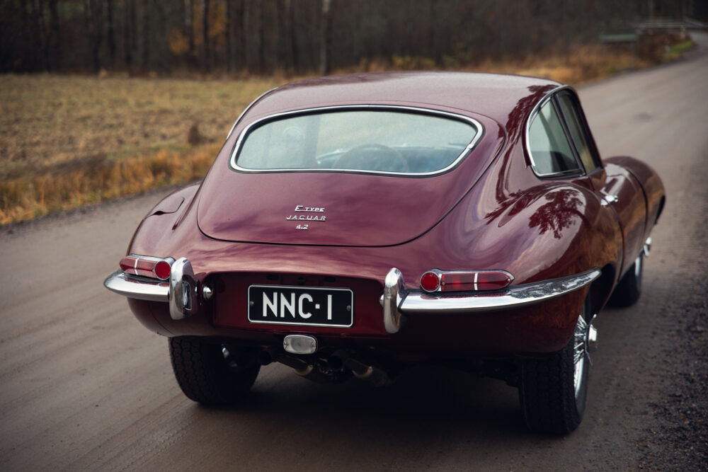 Vintage Jaguar E-Type on a forest road