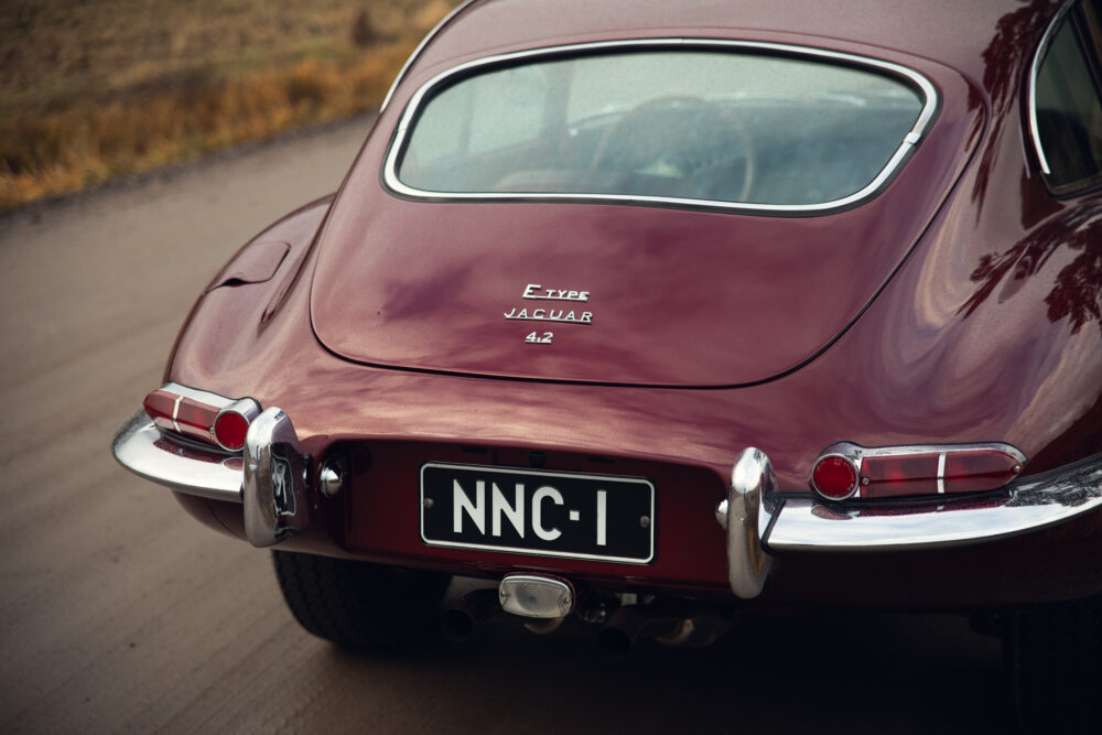 Vintage maroon Jaguar E-Type car rear view