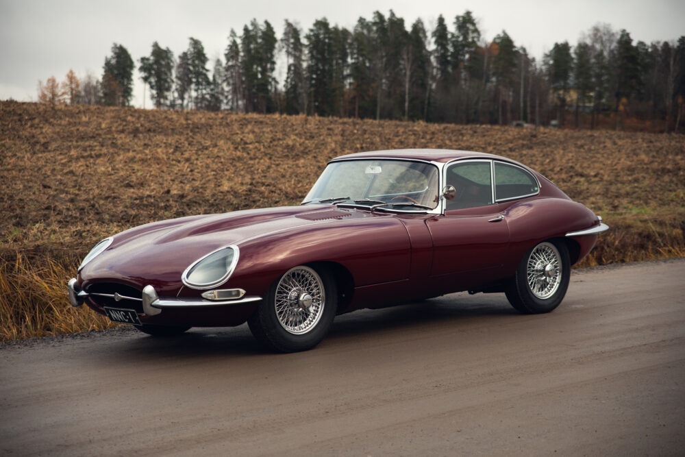 Vintage red Jaguar E-Type car on rural road