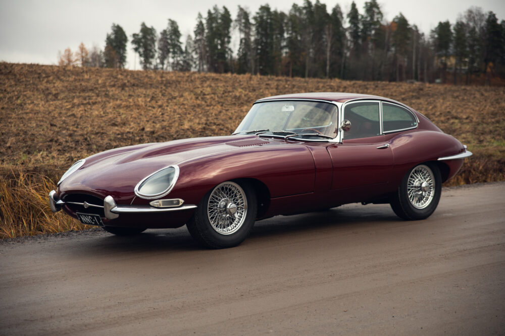 Vintage red Jaguar E-Type car on rural road