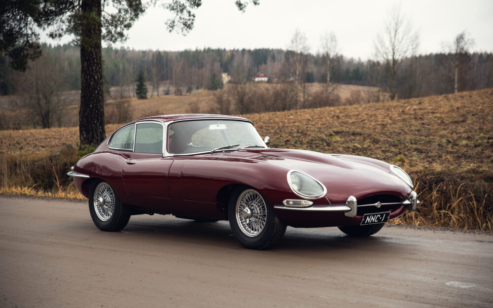 Classic red Jaguar E-Type on rural road