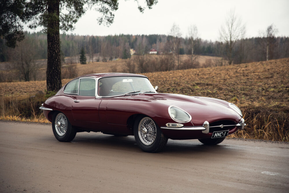 Classic red Jaguar E-Type on rural road