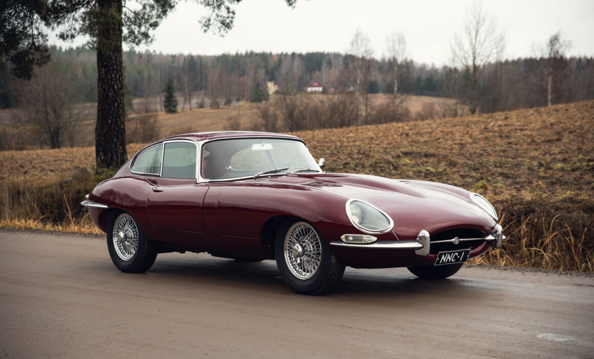 Classic red Jaguar E-Type on rural road