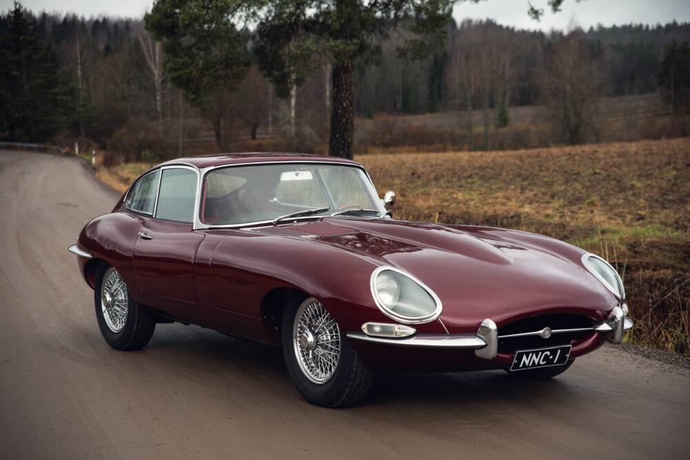 Vintage red Jaguar E-Type on a country road