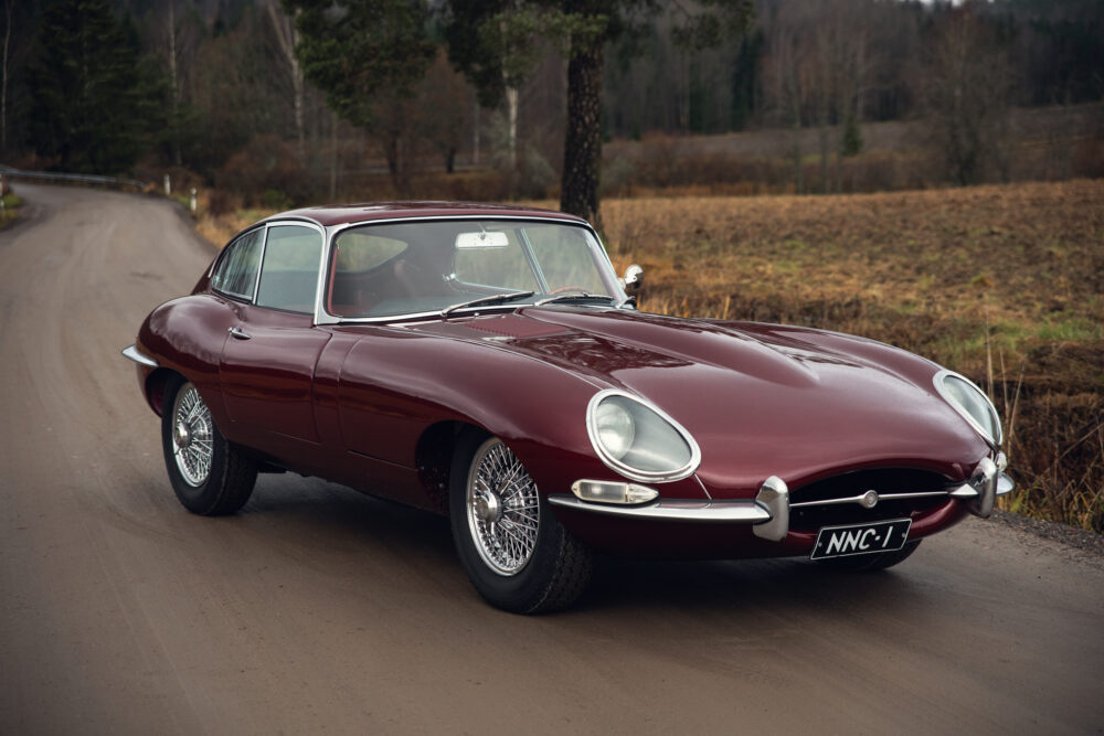 Vintage red Jaguar E-Type on rural road