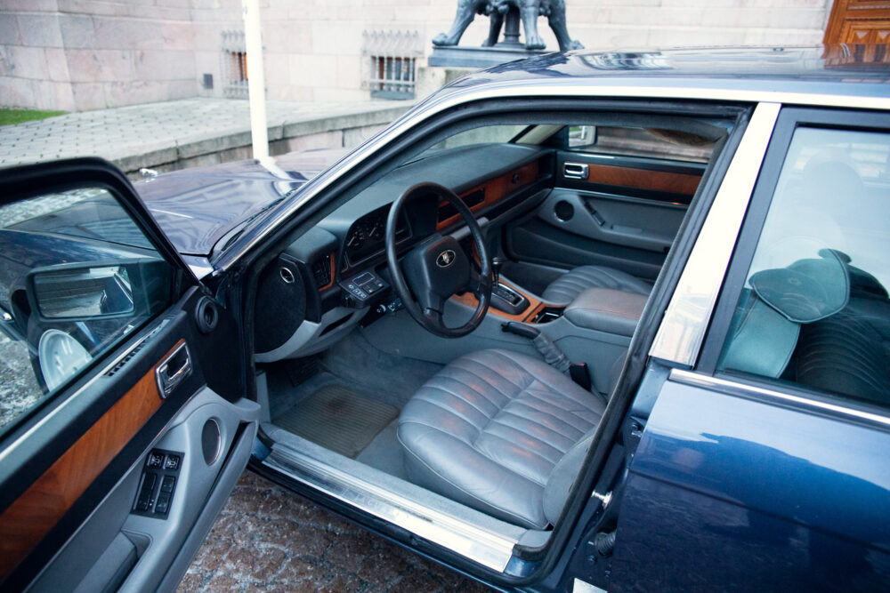 Vintage car interior with open door, luxurious design