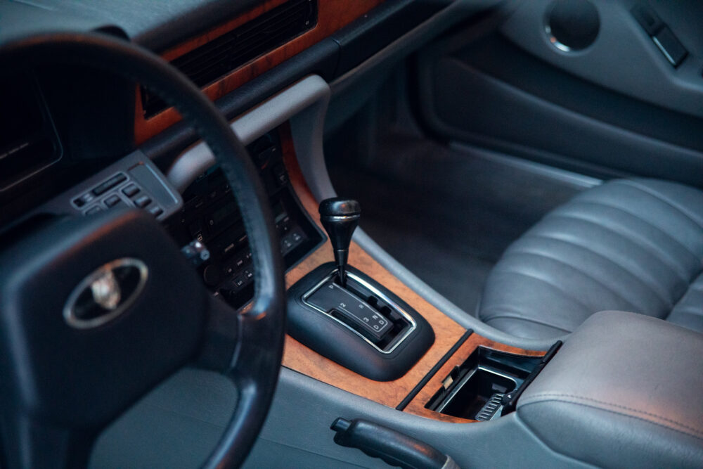 Luxury car interior with wooden accents and gear shift