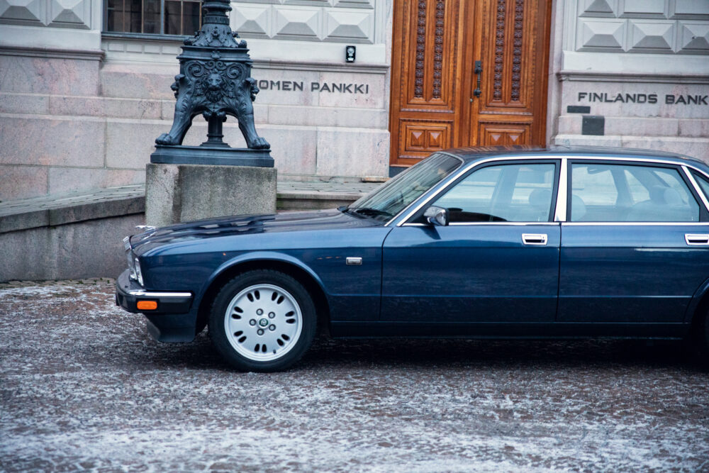 Vintage blue car parked near historic building
