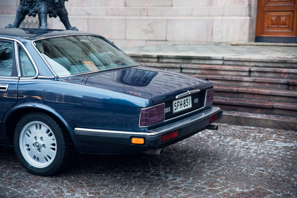 Vintage black Jaguar car parked near stone steps