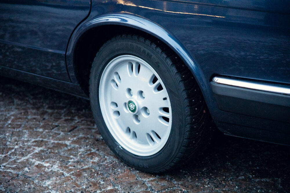 Close-up of a car tire on snowy pavement