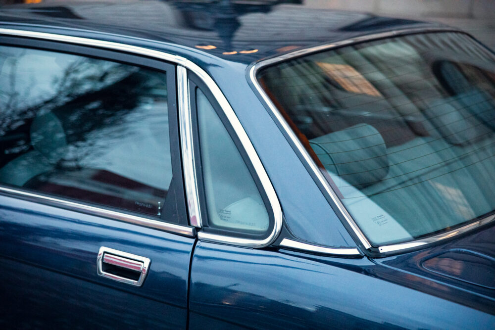 Close-up of blue car's side window and door