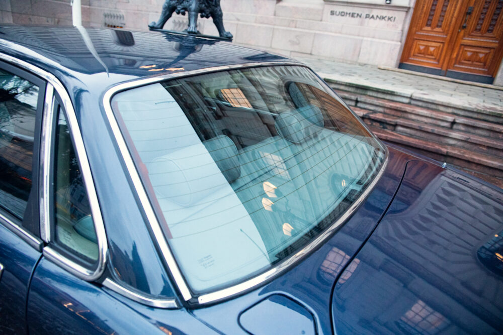 Blue car parked near ornate building entrance