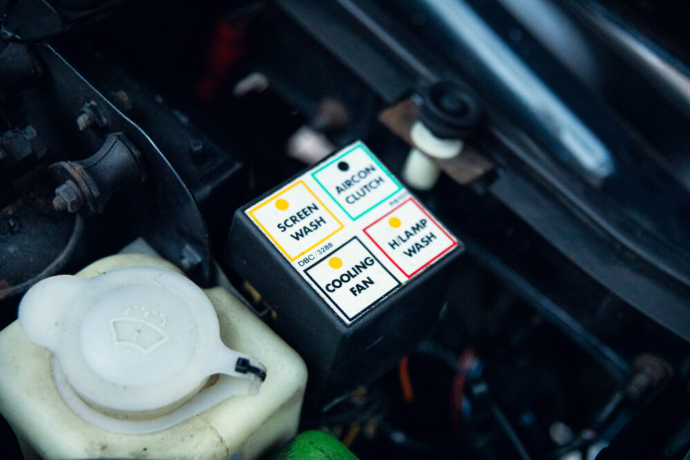 Car engine showing labeled electrical control buttons