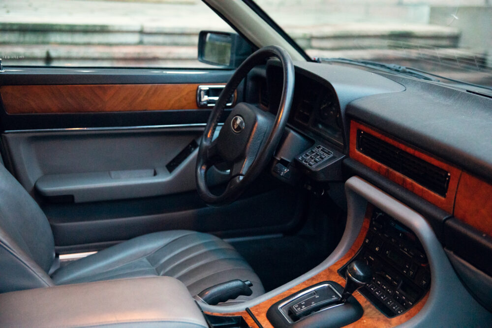 Vintage car interior with wooden accents and steering wheel