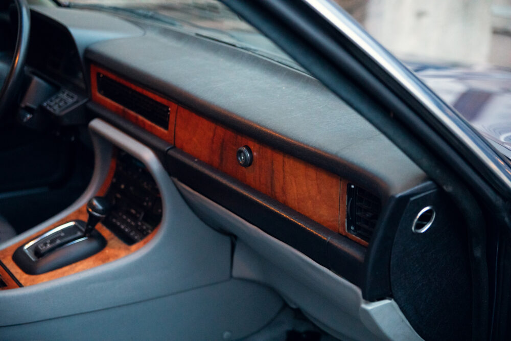 Vintage car interior with wooden dashboard and leather seats