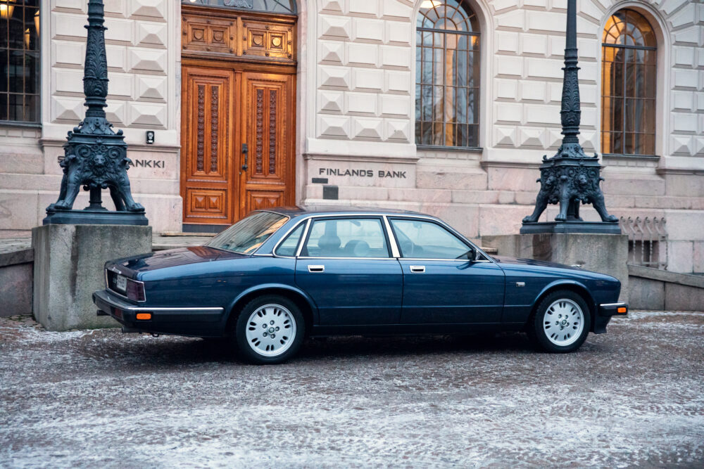 Vintage blue car parked outside Finland's Bank building