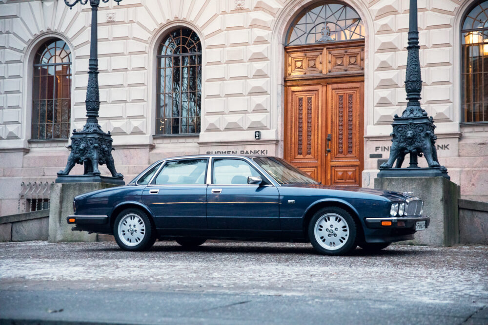 Vintage car parked outside elegant building