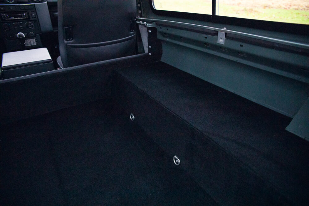 Interior view of a van showing dark carpeted cargo area