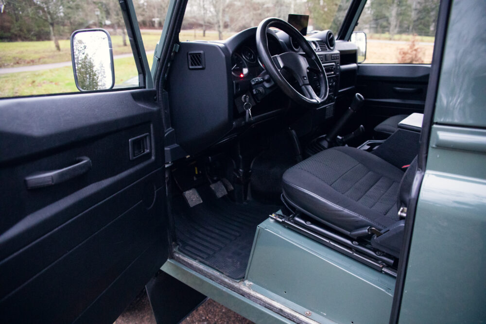 Interior view of vintage green SUV with open door