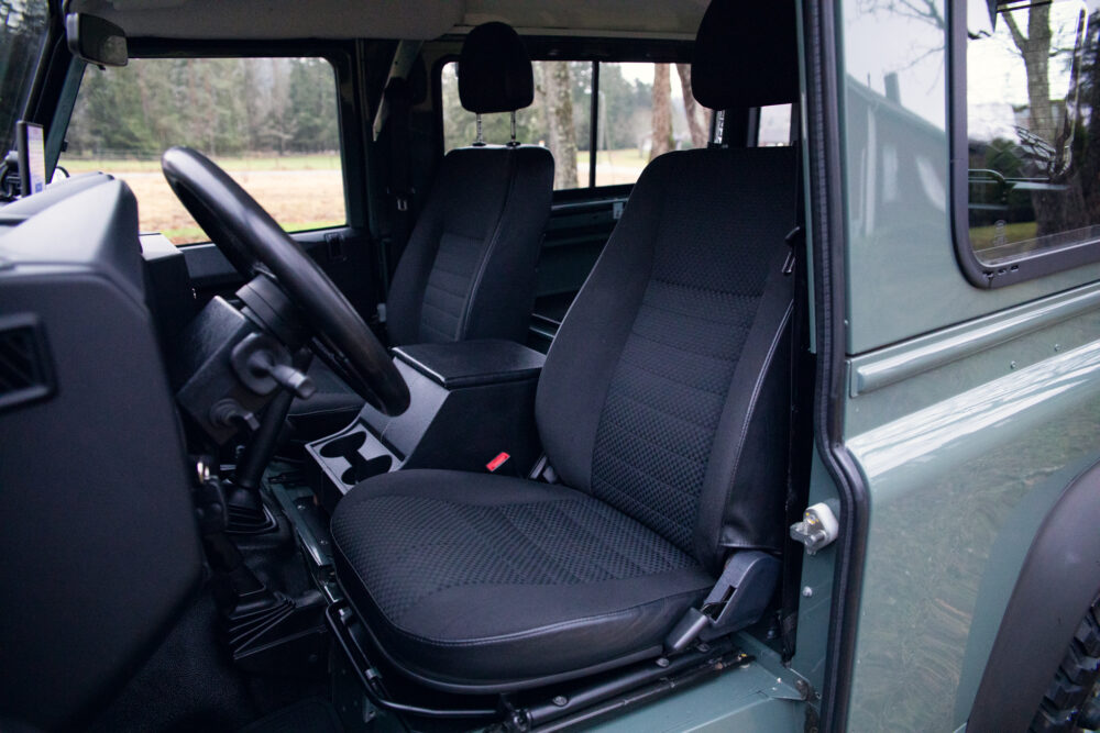 Interior view of SUV with front seats and steering wheel