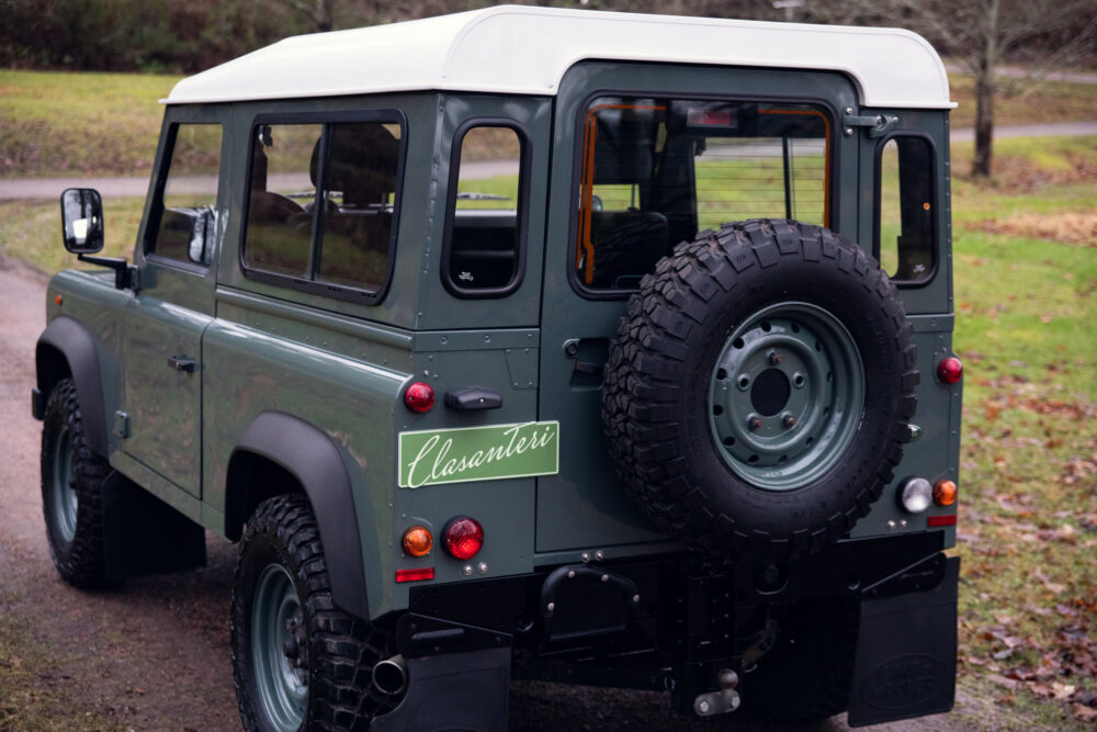 Classic green Land Rover with spare tire mounted