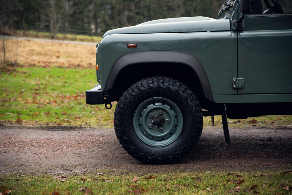 Green off-road vehicle in a scenic outdoor setting