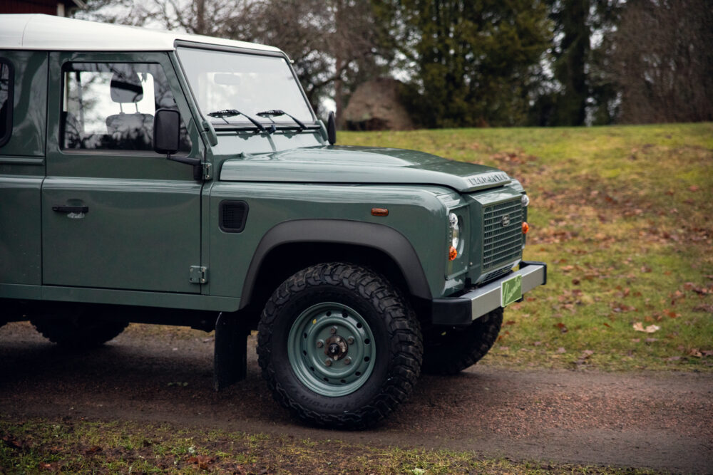 Green off-road vehicle parked outdoors on a cloudy day
