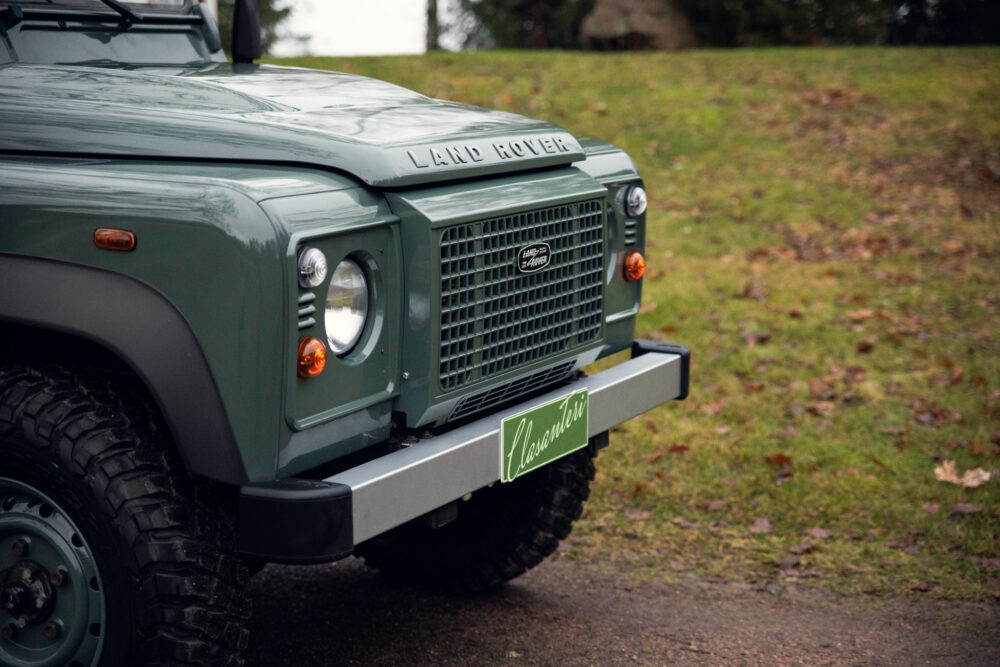 Green Land Rover close-up on grassy field