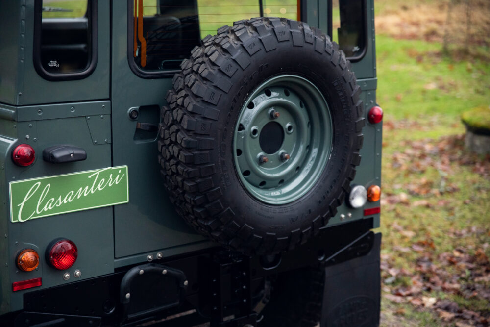 Spare tire mounted on a green off-road vehicle