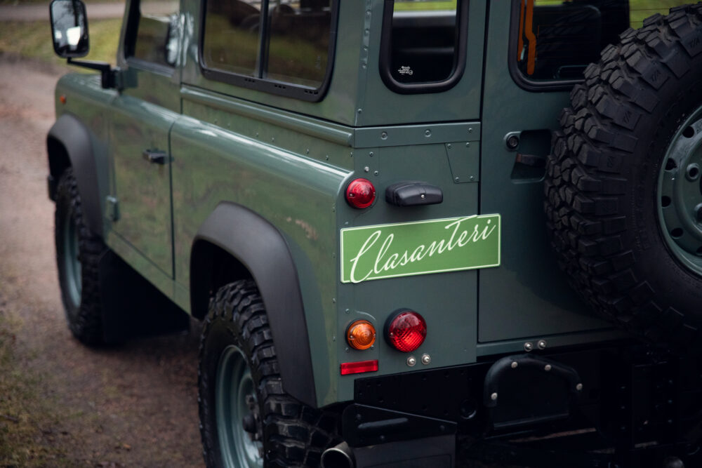 Green off-road vehicle rear view with custom plate