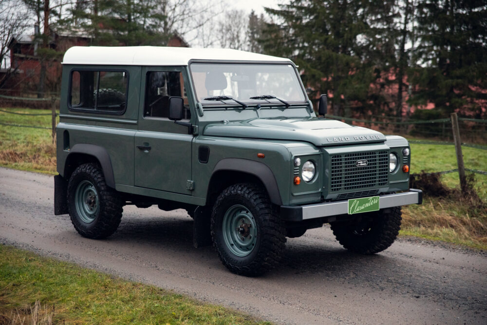 Green Land Rover Defender parked outdoors