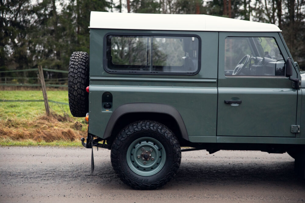 Green off-road vehicle parked on rural road