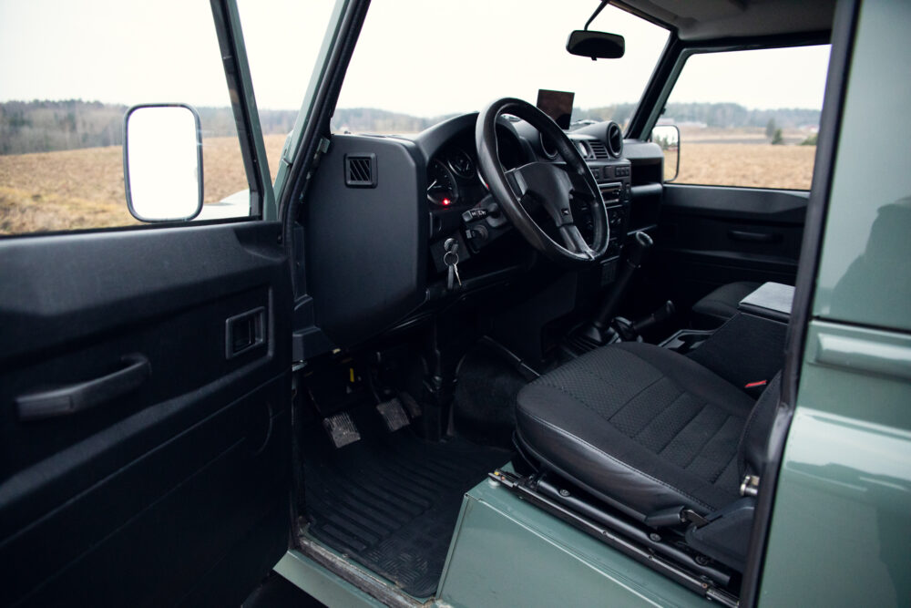 Interior view of vintage green SUV with open door