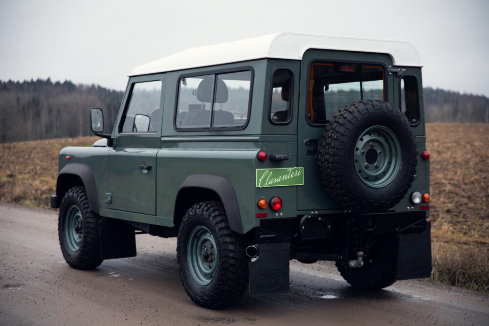 Green off-road vehicle parked on a dirt road