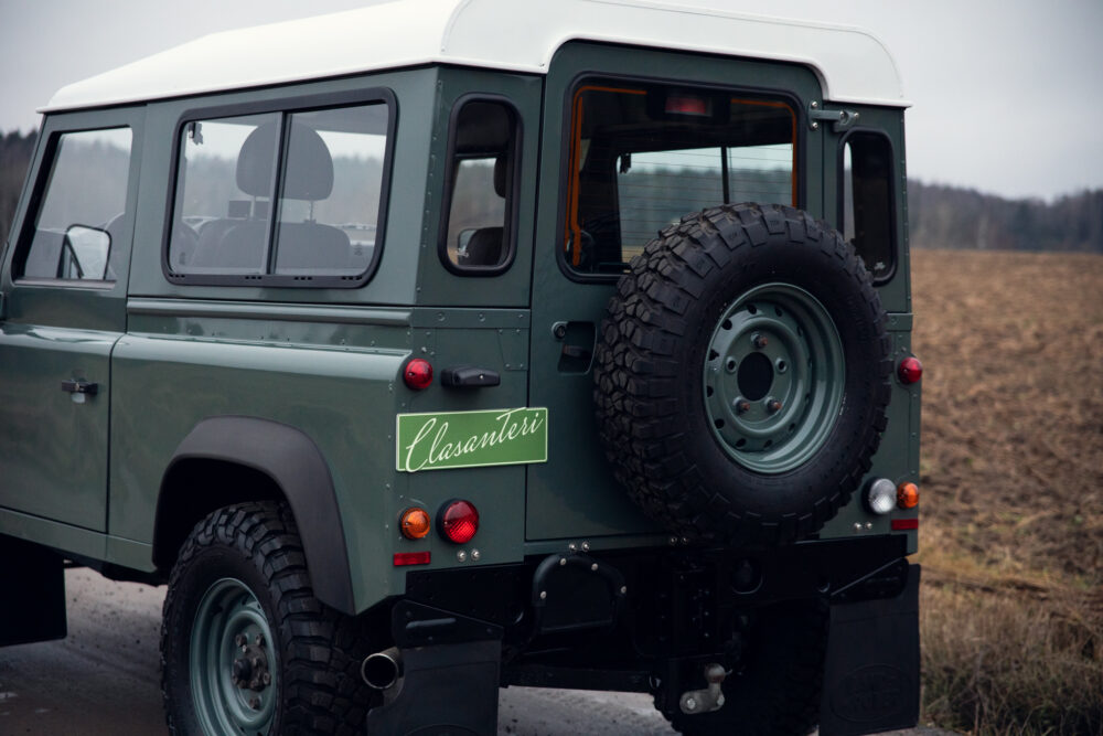 Vintage green SUV with rear-mounted spare tire