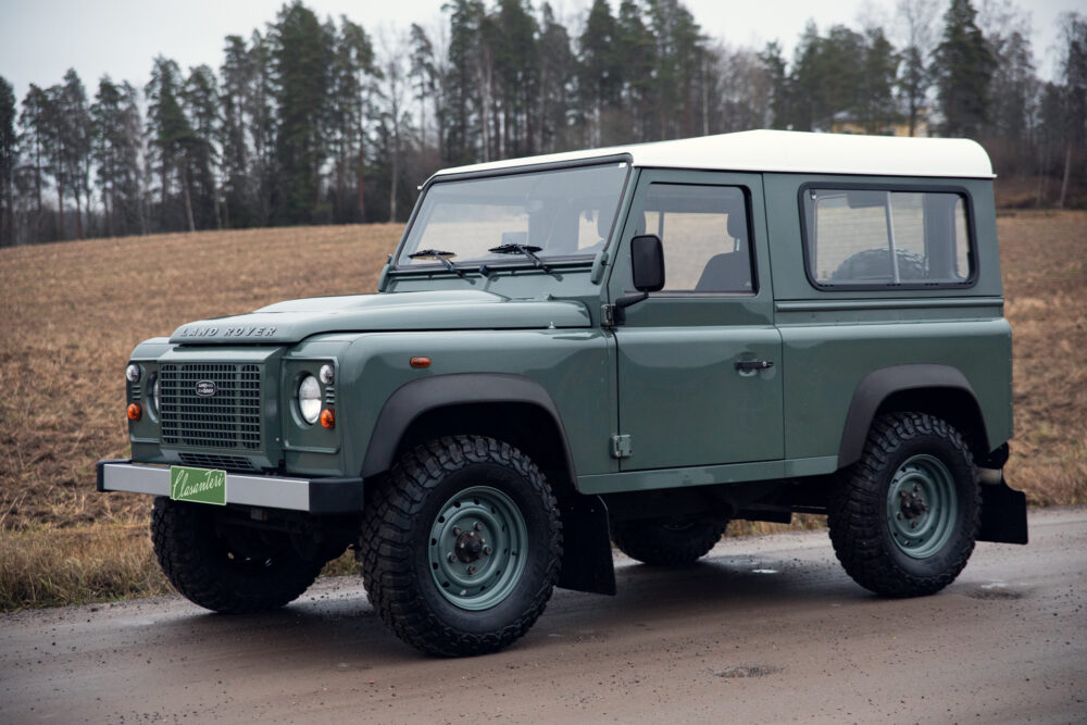 Green Land Rover Defender parked outdoors