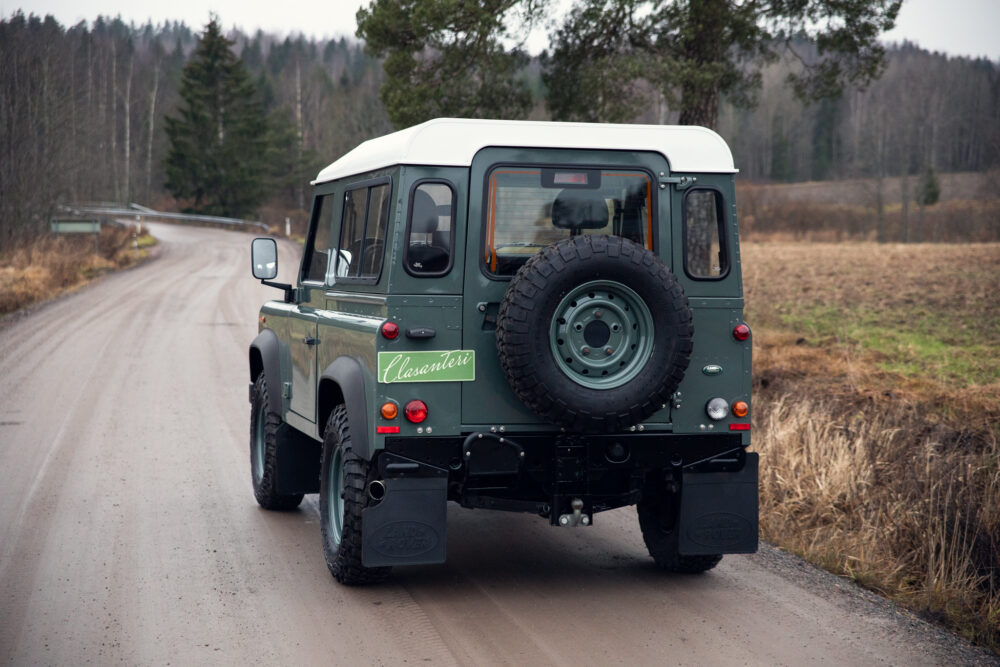 Green vintage SUV on rural road