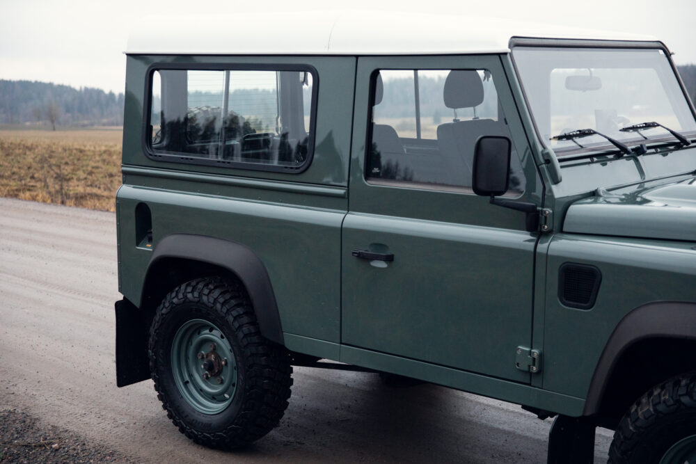 Green off-road vehicle on a rural road