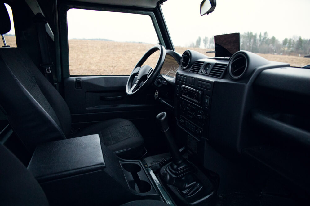 Interior view of vehicle showing steering wheel and dashboard