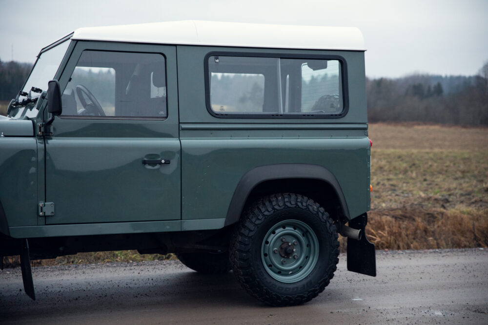 Green off-road vehicle parked on rural road